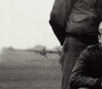 Judging by the parked heavy bomber (perhaps a B-17) and the close proximity combined with the landscape, I am betting that this photo was taken somewhere in England in 1943-1945.